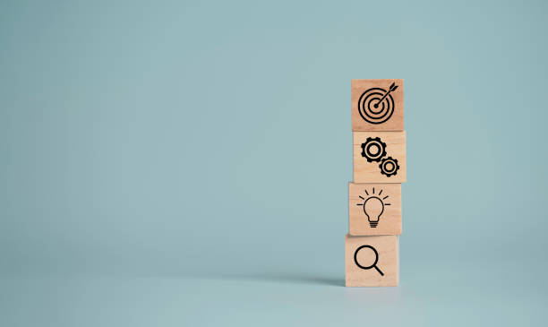 istock Target board with arrow print screen on wooden cube block to setup objective target and investment goal. 1310441422