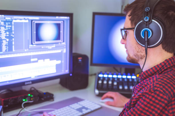 istock Video editor in the cutting room, close up, monitors in blurry background 1310442446
