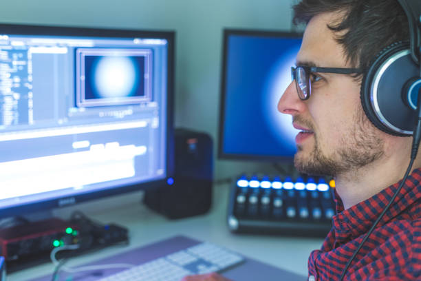 istock Video editor in the cutting room, close up, monitors in blurry background 1310442697