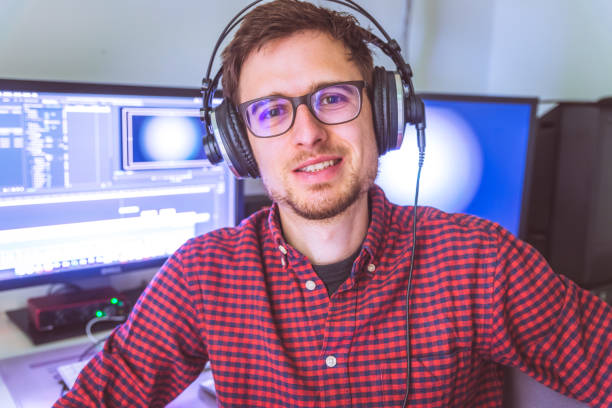 istock Video editor in the cutting room, close up, monitors in blurry background 1310442753