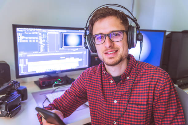 Video editor in the cutting room, close up, monitors in blurry background