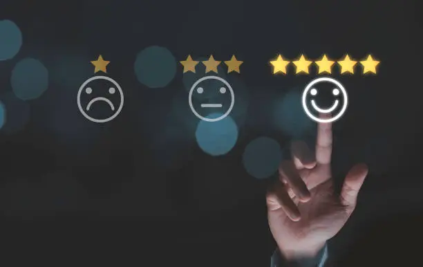 Photo of Businessman touching smile face icons with five gold stars on blue bokeh background, customer satisfaction for product and service concept.
