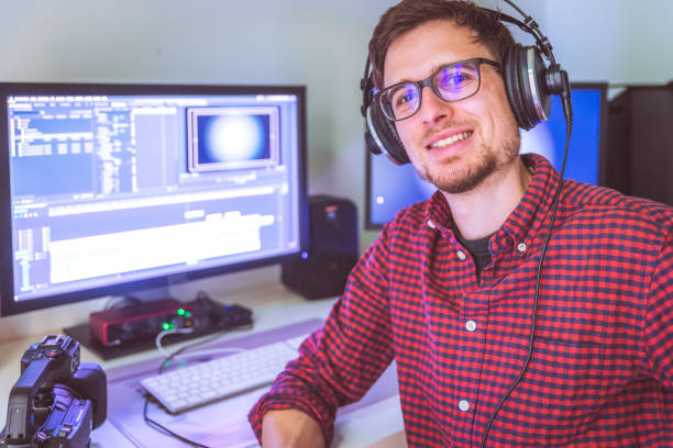 istock Video editor in the cutting room, close up, monitors in blurry background 1310443695