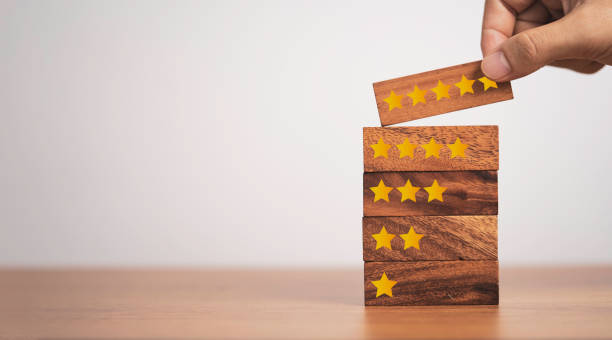 istock Hand putting five start which print screen on wooden cube block, customer satisfaction for product and service. 1310443716