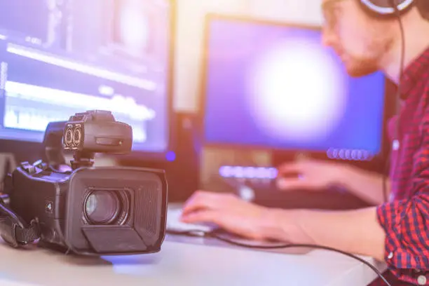 Photo of Professional cutting room for video editing and video producing: Monitors, camera and sound mixing