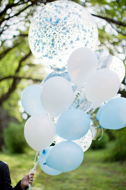 istock White and blue balloons with confetti 1310445685