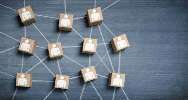 istock Wooden cubes with people icons connected 1310446492