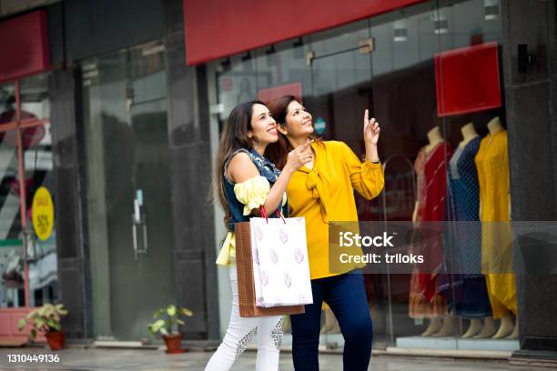 Two Carefree Women With Shopping Bags In City Stock Photo - Download Image Now - India, Retail, Shopping
