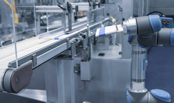 istock Robot loading cosmetic aluminum tube 1310449523