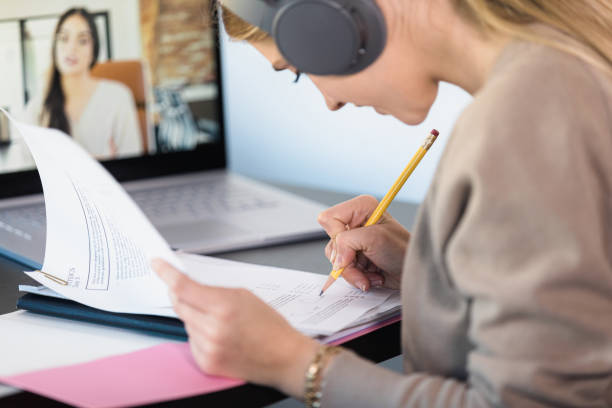 istock Student with headphones follows along during virtual math class 1310450550
