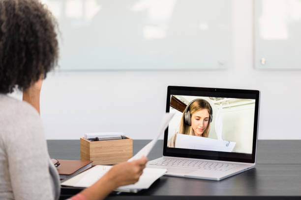 istock Female teacher discusses test with student during video chat 1310450611