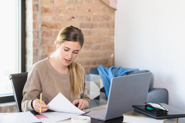 istock Female student studies with friend online 1310450634