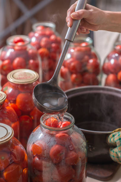 istock canning ripe tomatoes in the cans 1310452357
