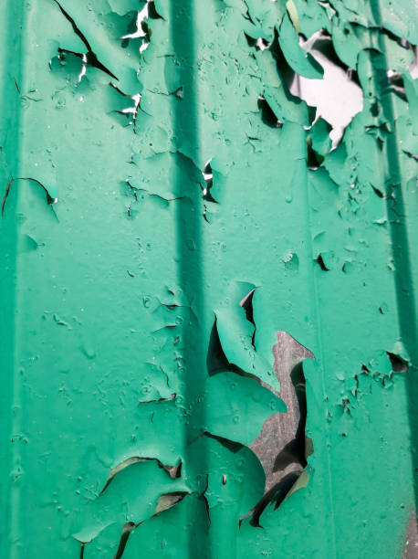 istock Green paint is peeling off the metal surface 1310453630