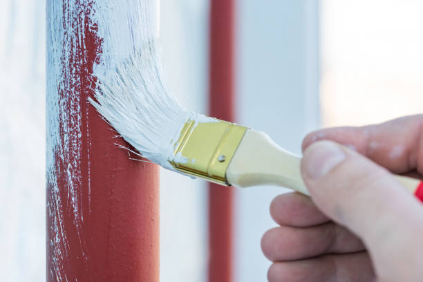 istock Worker's hand with brush that painting metal construction or pipes. 1310456753