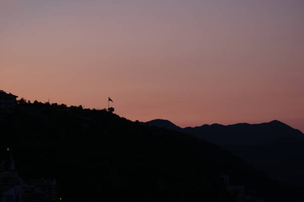 istock Silhouettes of mountains on red sunset sky background. 1310459399