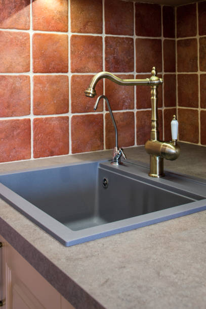istock stone kitchen sink bronze faucet 1310460845