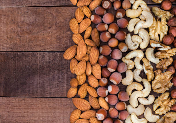 istock nuts of different types on a wooden table flat lay with a copy of the space 1310461962