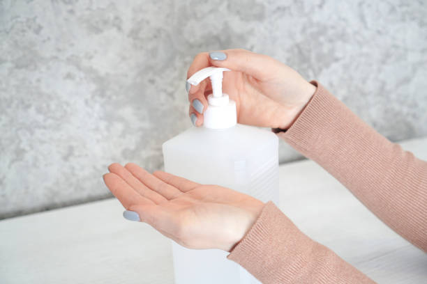 istock Woman uses a hand sanitizer pump. 1310462567