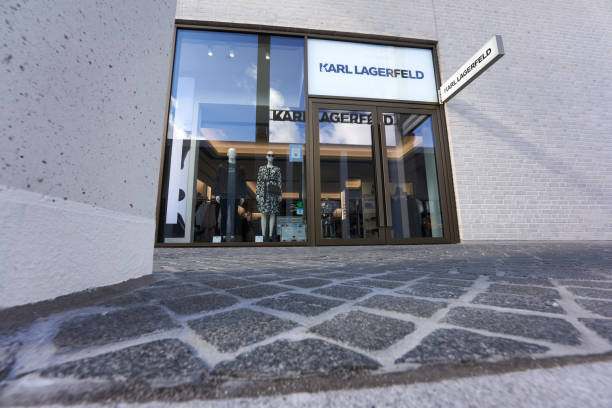 Karl Lagerfeld Outlet store. Bright exterior facade. Cobblestone in the foreground. Up view. Wide angle. Metzingen, Germany - March 20, 2021: Karl Lagerfeld Outlet store. Bright exterior facade. Cobblestone in the foreground. Up view. Wide angle. karl lagerfeld stock pictures, royalty-free photos & images