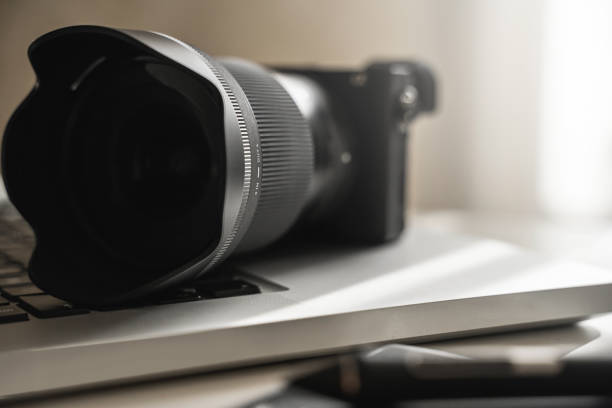 istock Photographer's workplace with a mirrorless camera, laptop and graphics tablet 1310462706