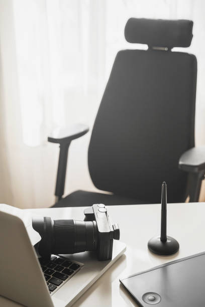 istock Photographer's workplace with a mirrorless camera, laptop and graphics tablet 1310463284