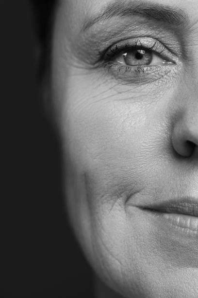 Pretty middle aged woman with wrinkled skin Monochrome portrait of pretty middle aged woman with wrinkled skin halved photos stock pictures, royalty-free photos & images