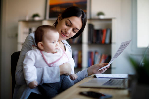 istock Smiling mother working from home 1310463813