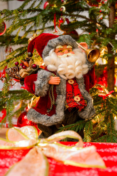 istock santa claus under the tree with gifts 1310467209