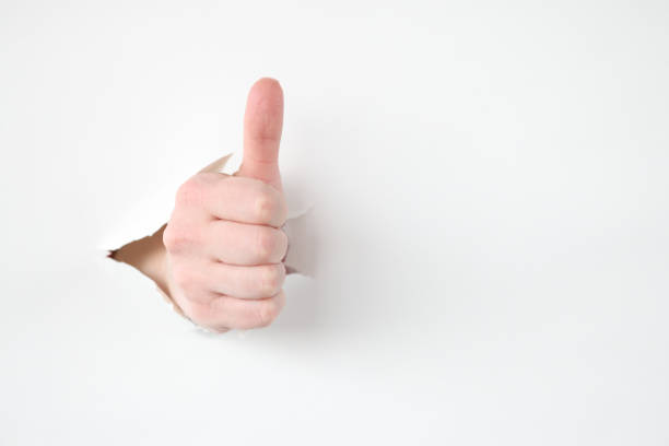istock Female hand makes thumbs up gesture closeup 1310469477