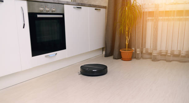 istock a robot vacuum cleaner in a bright modern kitchen on a white laminate background cleans up and makes a clean room 1310471434