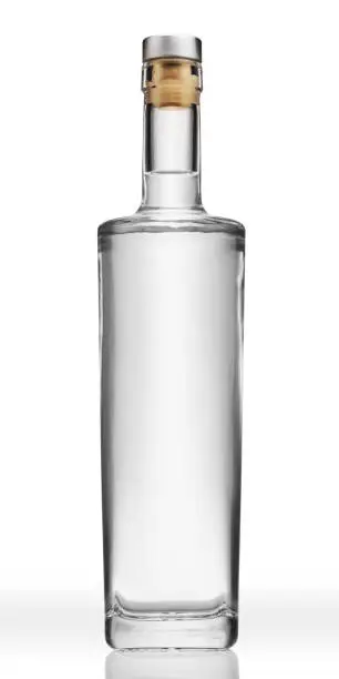 Bottle of transparent glass, with gin, tequila, rum, or vodka, isolated on pure white background.