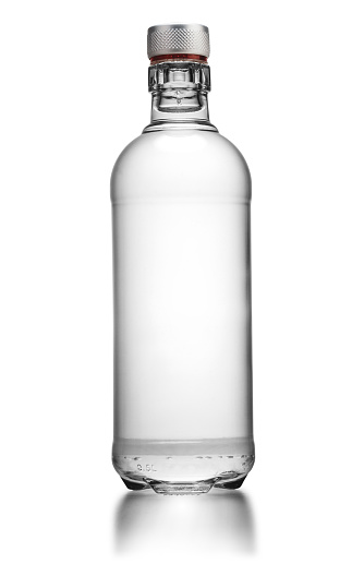 Bottle of transparent glass, with gin, rum, or vodka, isolated on white background.