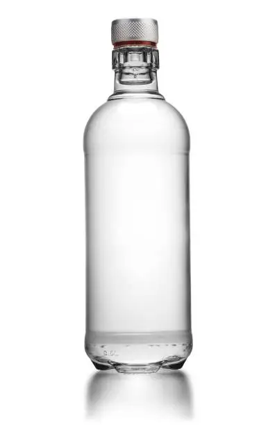 Photo of Bottle of transparent glass, with gin, rum, or vodka, isolated on white background.