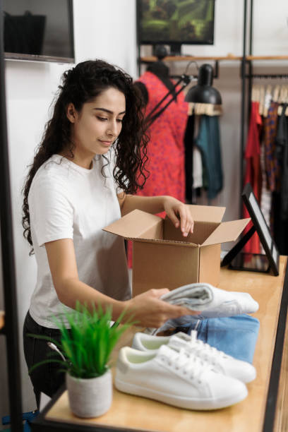 istock Woman packing merchandise for shipment 1310472666