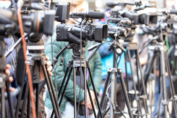 istock Filming press conference or media event with a television camera 1310472685