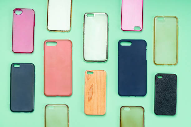istock Pile of multicolored plastic back covers for mobile phone. Choice of smart phone protector accessories on green background. A lot of silicone phone backs or skins next to each other 1310474128