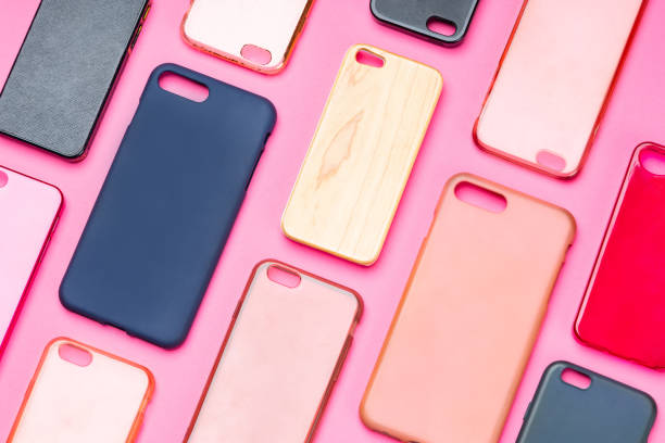 istock Pile of multicolored plastic back covers for mobile phone. Choice of smart phone protector accessories on pink background. A lot of silicone phone backs or skins next to each other 1310474146