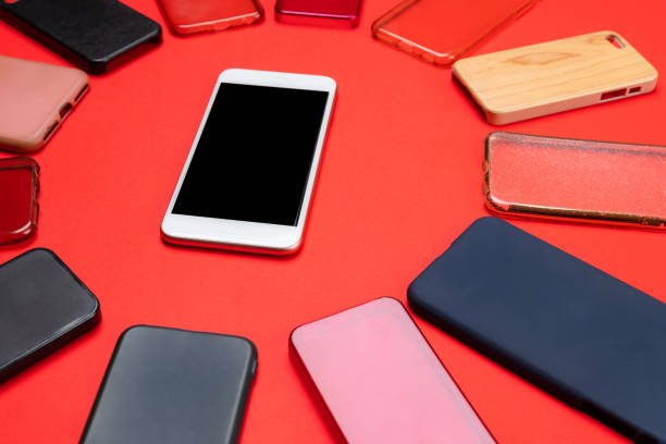 istock Choice of multicolored plastic back covers for mobile phones on red background with a smart phone on the side 1310474151