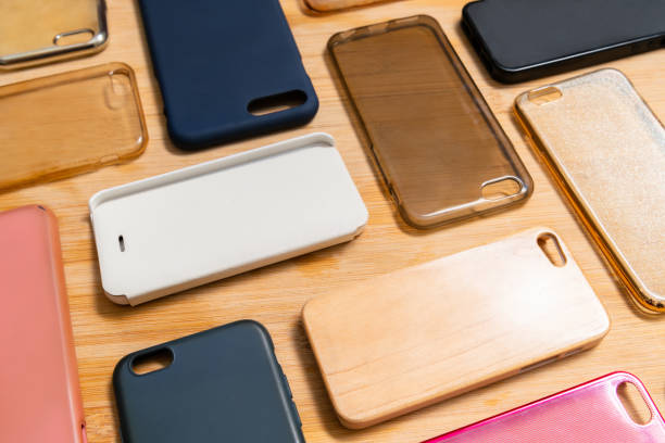 istock Pile of multicolored plastic back covers for mobile phone. Choice of smart phone protector accessories on wooden background. A lot of silicone phone backs or skins next to each other, pattern 1310474957