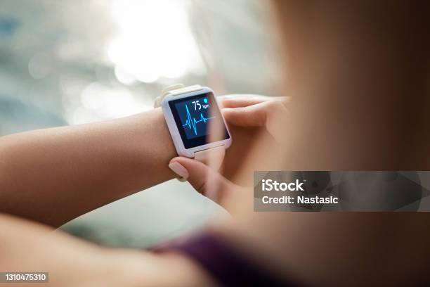Woman Looking At Her Smart Watch For A Pulse Trace Stock Photo - Download Image Now - Healthcare And Medicine, Healthy Lifestyle, Technology