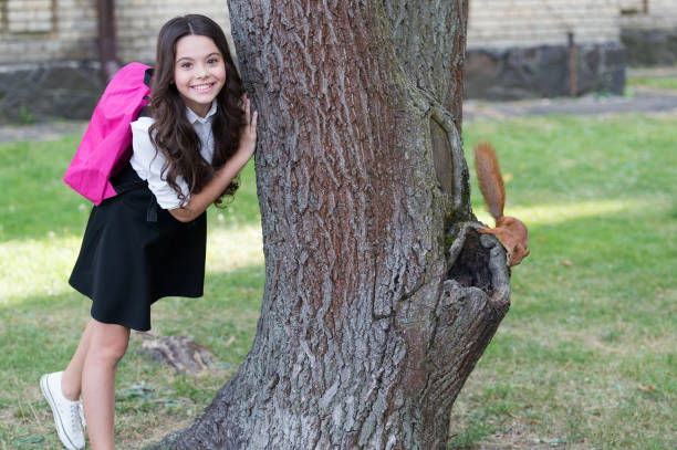 istock This squirrel is cute. Happy child stand at tree. September 1. Back to school. Knowledge day. School education. Private teaching. School time. Welcome autumn 1310476110