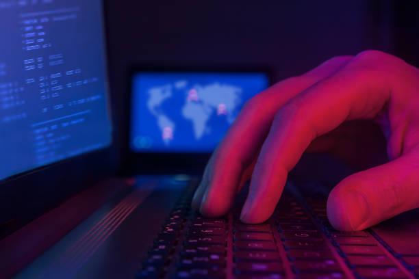 istock international hacking and worldwide cyberterrorism concept, hacker typing on keyboard in dark room 1310479031