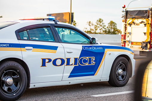 Orlando, USA - Feb. 12, 2021: Orlando police car on the road at day