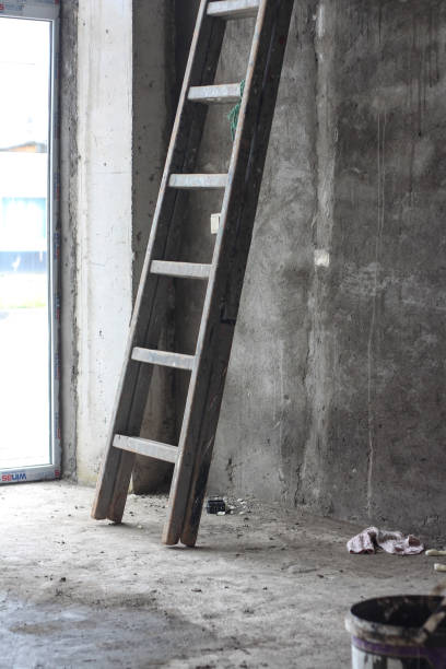 istock Metallic ladder inside the room with cement walls, home improvement 1310485741