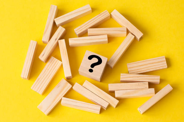 istock wooden blocks with a wooden cube with question mark in the middle 1310486681