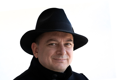 Portrait of stylish mature man with his classic round hat.