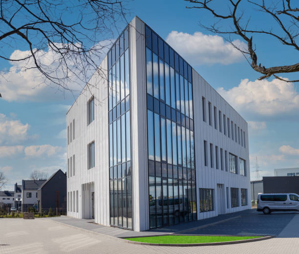 istock Modern business corporate office building and blue sky. 1310487719