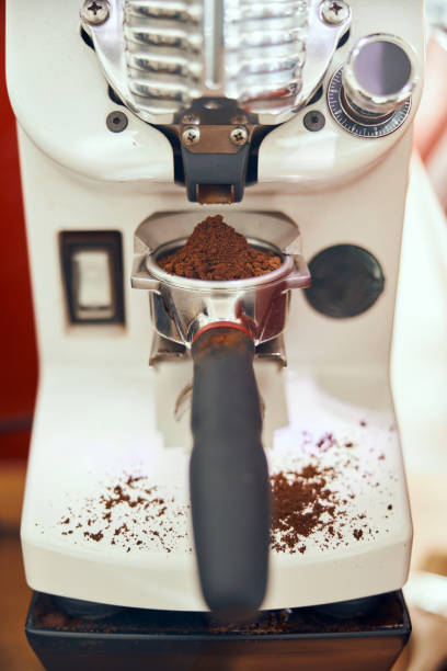istock Ground coffee pouring into a portafilter with a grinder 1310492244