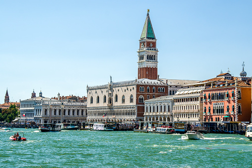Venice, Veneto, Italy - August 14, 2016: Venice, the capital of the Veneto region, sits on more than 100 small islands within a lagoon in the Adriatic Sea. In the image, the bell tower of San Marco emerges from the Grand Canal